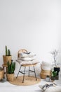 chair, decorative pillows and plants in apartment with bohemian style Royalty Free Stock Photo