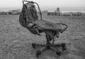Old, ruined office chair in the desert