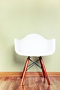 Chair in empty room against a green wall Royalty Free Stock Photo