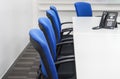 Chair with IP phone on white meeting table in office