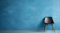 a chair leaning against a blue grunge wall