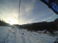 Chair lift in the mountains in winter. outdoor activities, snowboarding or skiing, uphill walking. Sunny day in winter