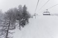 Chair lift in ski center les arcs, paradiski on the french alps on a winter snowy day