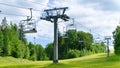 Chair lift in summer. The concept of uselessness. Empty ski lift during off-season. Beautiful landscape with a ski lift in the Royalty Free Stock Photo