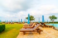 chair pool or bed pool and umbrella around swimming pool with sea beach background Royalty Free Stock Photo