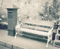 Chair and postbox roadside in garden, vintage tone