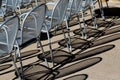 Metal mesh chair shadows on the ground.