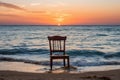 a chair sitting on the beach at sunset