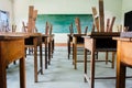 chair and table in class room with black board background Royalty Free Stock Photo