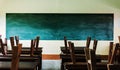 Chair and table in class room with black board background, no student, Royalty Free Stock Photo