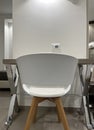 Chair and Table, Workplace. Stylish Living Room Interior with Comfortable Chair and Small Table Near White Wall. Place for Text