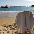 chair to rest with a white towel on the sand of the beach of Acapulco, Mexico on a sunny day Royalty Free Stock Photo