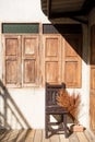 Chair , wooden windows and warm sunrise