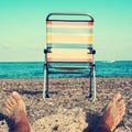 Chair and young man on the beach, filtered