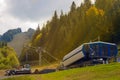 Chairlift bottom base and snow plow bulldozers in a warm sunbeam mountain scene