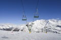 Chairlift at Italian ski area on snow covered Alps during the winter - winter sports concept Royalty Free Stock Photo