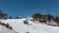 Chairlift over a snowy mountain slope. Royalty Free Stock Photo