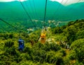 Chairlift ropeway single person sitting watching scenic view of mountains at Rajgir, Bihar, Patna, India