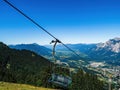 Chairlift ski lift chair going upwards no people empty in Austria, Carinthia, during summer with mountains in the background, Royalty Free Stock Photo