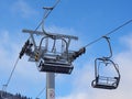 Chairlift ski lift in winter. Close up of an empty chair in a ski lift. The chairlift is out of order. Closed ski resort