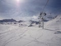 Chairlift on the ski slopes in european alps sunny day Royalty Free Stock Photo