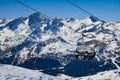 Chairlift with skiers and snowboarders going up to the peak at Ski Resort.