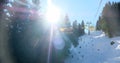 chairlift with snow and trees underneath the blue sunny sky Royalty Free Stock Photo