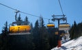 chairlift with snow and trees underneath the blue sunny sky Royalty Free Stock Photo