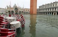 Chairs of the alfresco cafe in Saint Mark Square  flooded during high tide in  Venice Royalty Free Stock Photo