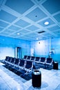 Chairs in blue airport hall Royalty Free Stock Photo