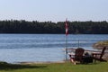 Chairs looking over beautiful lake view with Canada flag