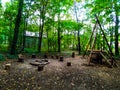 Chairs made of wood in the forest, a place for a fire. On the right is a swimming structure. Royalty Free Stock Photo