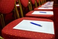 Chairs with notepads and pens in empty conference room Royalty Free Stock Photo