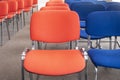 Chairs red and blue in row. Empty seats in a meeting room or auditorium. Selective focus Royalty Free Stock Photo