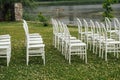 Chairs set up by the green lawn in preparation for a wedding reception