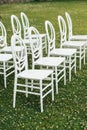 Chairs set up by the green lawn in preparation for a wedding reception