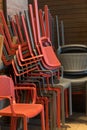 Chairs stacked one on top of the other in a corner Royalty Free Stock Photo