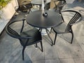 chairs, tables and black ashtrays in a cafe that I passed Royalty Free Stock Photo