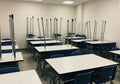 Empty classroom with chairs stacked on desks ready for cleaning or rearrangement modern educational space Royalty Free Stock Photo