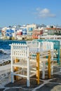 Chairs with tables in Greek tavern in Little Venice part of Mykonos town, Mykonos, Greece Royalty Free Stock Photo