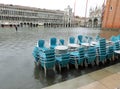 Chairs and tables submerged by high water during the high tide i Royalty Free Stock Photo