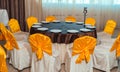 Chairs with yellow cloth and table for guests served for wedding. Royalty Free Stock Photo