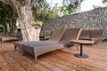 Chaise longues in the garden beside swimming pool. Royalty Free Stock Photo