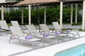 Chaise lounge chairs next to pool