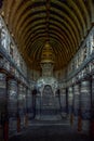 Chaitya interior showing standing Buddha figure over the stupa. Ajanta Caves, Aurangabad, Maharashtra