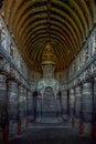 Chaitya interior showing standing Buddha figure over the stupa. Ajanta Caves,