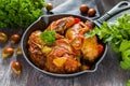 Chakhokhbili, chicken stew, cooked with tomatoes, bell peppers, spices and herbs. Dark wooden background Royalty Free Stock Photo