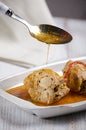 Chakhokhbili, traditional Georgian dish of stewed chicken, tomato and pepper with fresh herbs on wooden background, vertical shot Royalty Free Stock Photo