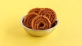 Chakli Indian Savory Snack in a Steel Bowl