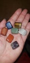 Chakra healing stones laid out in my hand